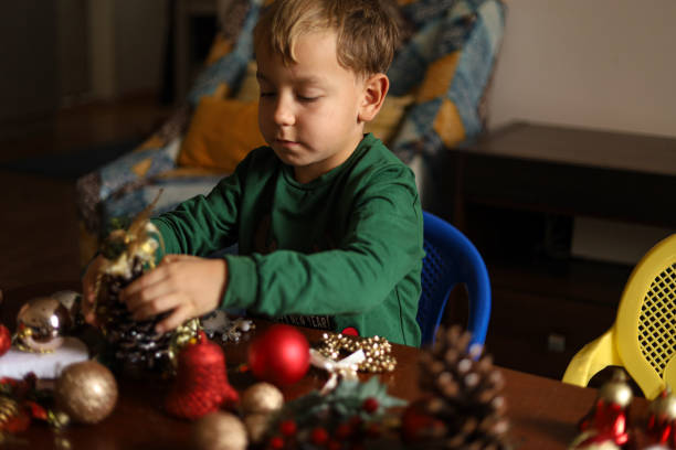 istock A little boy is playing with Christmas ornaments 1444688787