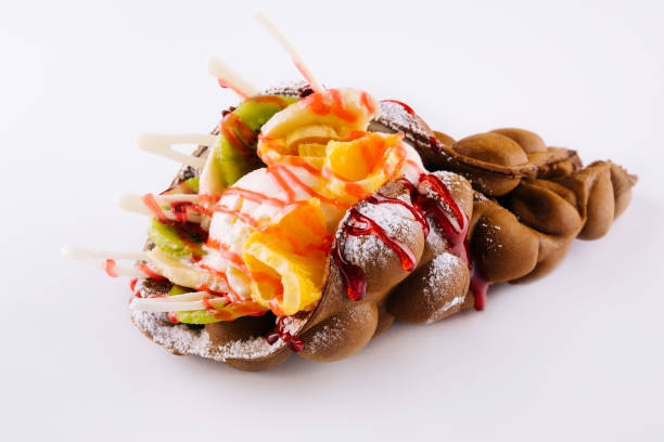 istock Egg waffle with ice cream and fruits with syrup 1444696674