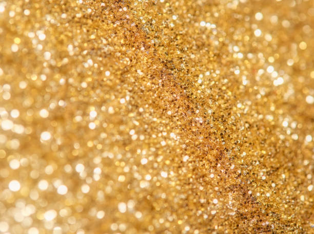istock Glitter macro background with blur and selective focus, in gold color 1444697327