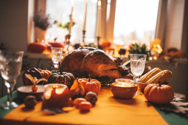 istock Thanksgiving holiday dinner table setting with fall decoration and pumpkins 1444700155