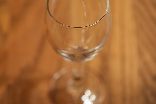 Macro takes a picture of a wine glass.