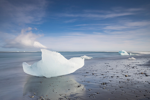 beautiful blue colored blocks of ice from the Vatnajokull glacier that have washed up on the black sand of Diamond Beach in Iceland; Jokulsarlon, Iceland