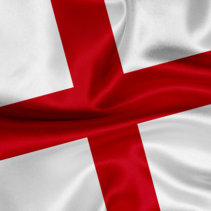 Flag of England blowing in the wind. \nFull page England flying flag.