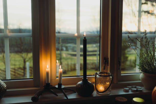 Scented candles on the windowsill with a view of the mountains and forest out of the window - a warm and cozy weekend in Norway
