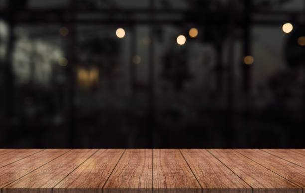 istock Empty wooden table top with lights bokeh on blur restaurant background. 1444712120