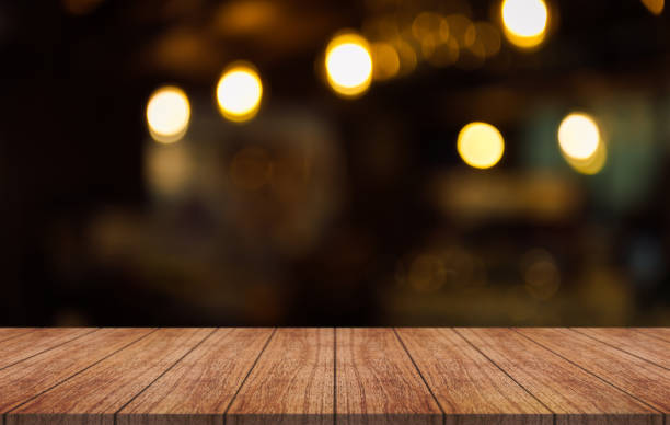 istock Empty wooden table top with lights bokeh on blur restaurant background. 1444712122
