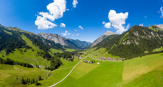Aerial view of a valley with a small mountain village in the Alps
