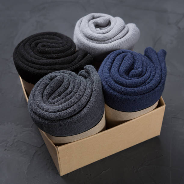 istock Four rolled up men's socks in a box, concept 1444720530