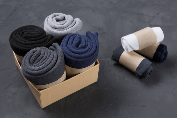 istock Four rolled men's socks in a box, and three rolls of socks lie side by side 1444720576