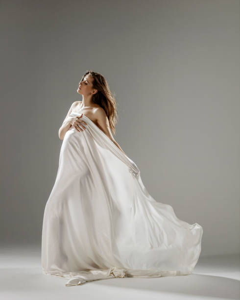 istock Pregnant women covered with light silk fabric 1444722488
