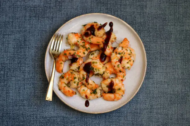 Photo of Asian style cooked shrimp with hot spices on a plate.