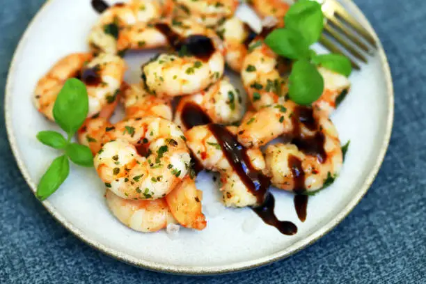 Photo of Asian style cooked shrimp with hot spices on a plate.