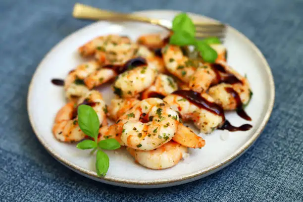 Photo of Asian style cooked shrimp with hot spices on a plate.