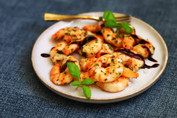 Photo of Asian style cooked shrimp with hot spices on a plate.