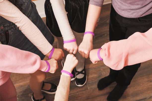 istock hands of girls with same bracelets, team building, cooperation, support and teamwork. Unity and togetherness concept. 1444723002