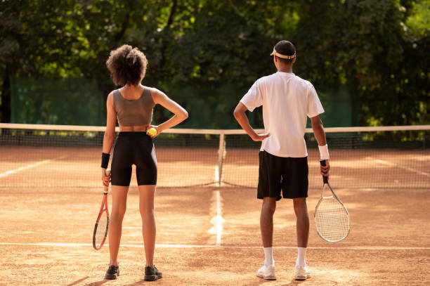 istock Two young people having a workout at tennis court 1444723626