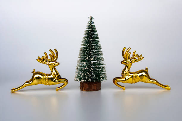 istock Reindeer and Christmas tree on white background with customizable space for text. Copy space and Christmas celebration concept. 1444725212