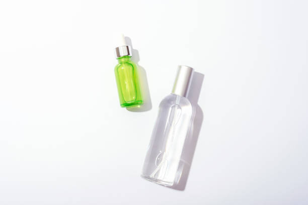 istock Cosmetic bottles with serum and tonic on white background, sharp shadows. Natural cosmetics concept. Top view, flat lay 1444725947
