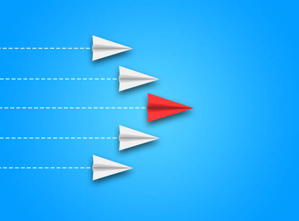 istock Leadership or different concept with red and white paper airplane path and route line on blue background. 1444726359