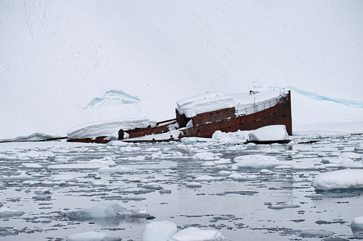 A sunken metal whaling boat, Gouvernoren, is trapped in the Ice of Antarctica Enterprise Island.