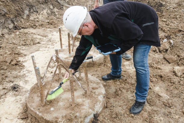 istock Piles cleaning. Engineer clears a place for pile integrity test. Pile foundation after completed. Reinforced concrete piles of the new building. Concrete pile foundation for new construction site. 1444738276