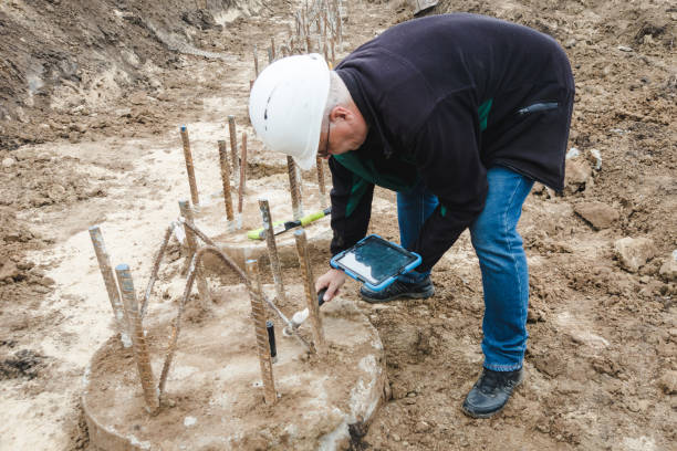 istock Construction works. Seismic test on concrete pile. Engineer using the PIT Hand-Held Hammer, the PIT Accelerometer and the Pile Integrity Tester to detect Neck Bulge and Void in the piles 1444738286