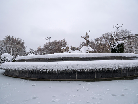 Neptuno fountain with snow. Madrid. Spain