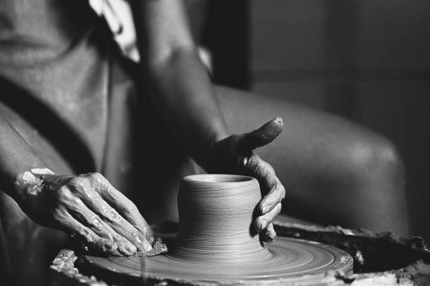 Woman hands working on pottery wheel and making a pot