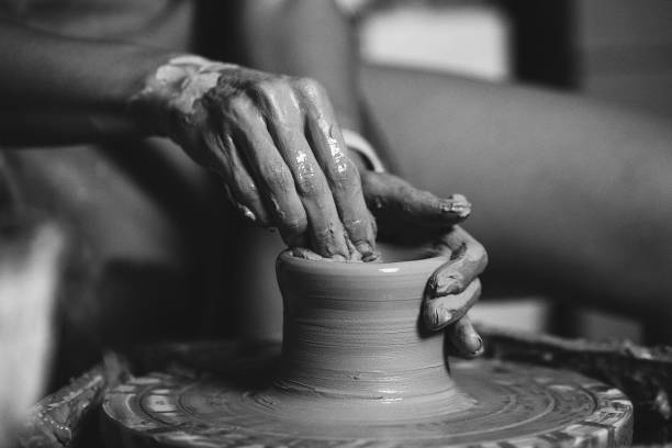 istock Woman hands working on pottery wheel and making a pot 1444738936