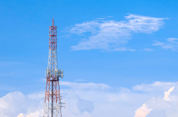 istock Large Communication telecom tower with antenna against white clouds on blue sky background 1444739371