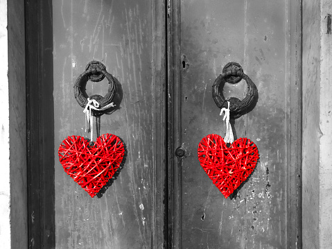 Red heart shaped padlock hangs on the bridge of lovers.  Concept - symbol of love and loyalty.