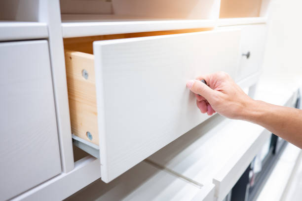 istock Male hand opening drawer on white cabinet 1444742635