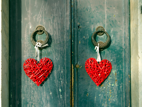 Decorative hearts on green door