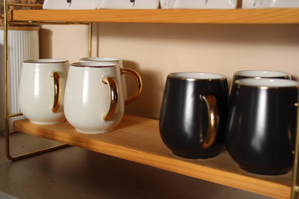istock Black and white coffee cups on the shelf 1444744535