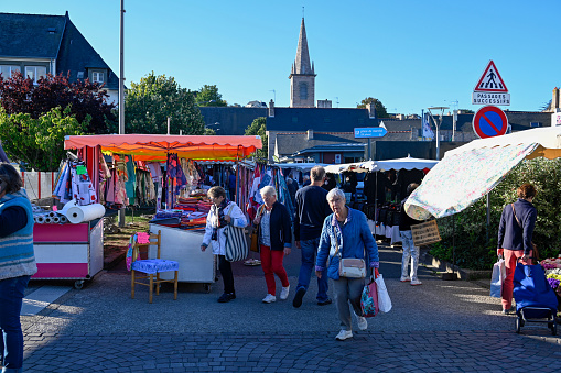 Erquy, France, September 17, 2022 - Tourists and locals at the weekly market in downtown Erquy, Brittany.
