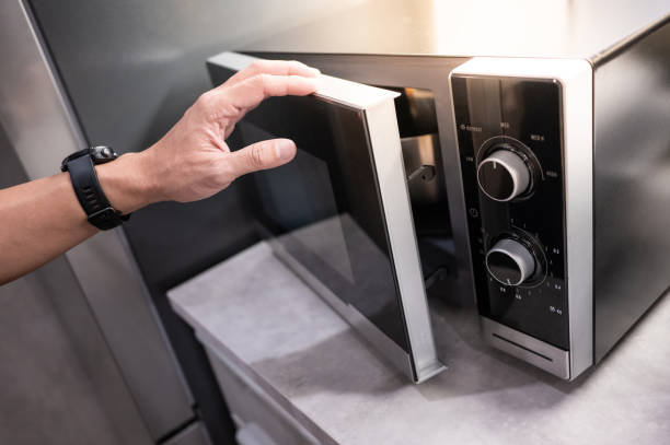 Male hand opening microwave door
