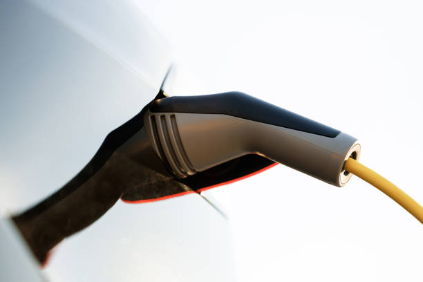 istock Charging technology, Clean energy filling technology. Electric car charging. Type 2 connector plugged into charging port. Electric vehicle charging port plugging in car 1444752798
