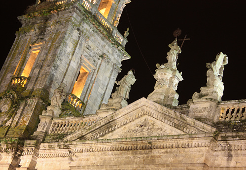Part of facade of Lugo city cathedral illuminated at night, Galicia, Spain.