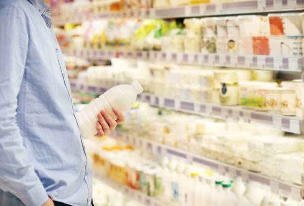 man choosing a dairy products at supermarket