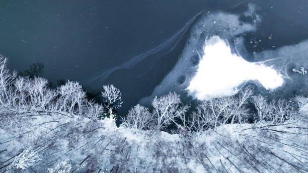 istock Flight over snowy forest and small river in Poland. 1444755782
