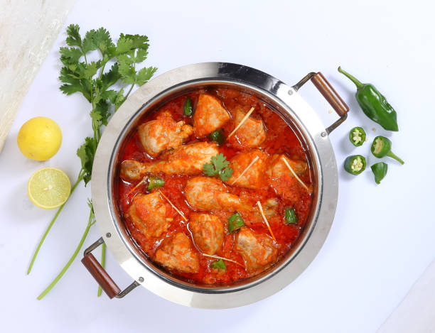 Chicken Karahi Traditional Pakistani Cuisine, Karahi garnished with lemons and green chilli karahi stock pictures, royalty-free photos & images