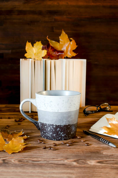 istock Big espresso coffee cup, tea mug with books,notebook,on table,hot beverage in autumn cozy evening 1444760556