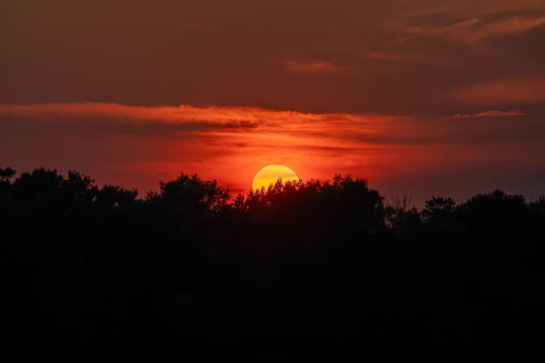 Sun close-up through telephoto lens at sunset stock photo