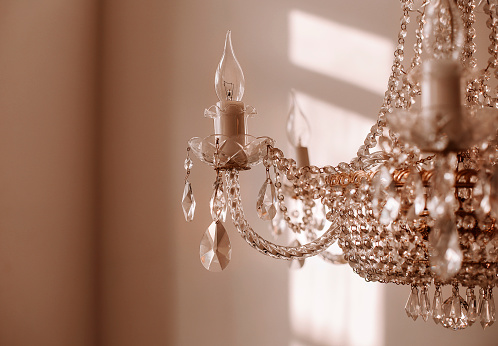 Chrystal chandelier close up. Glamour toed background with copy space