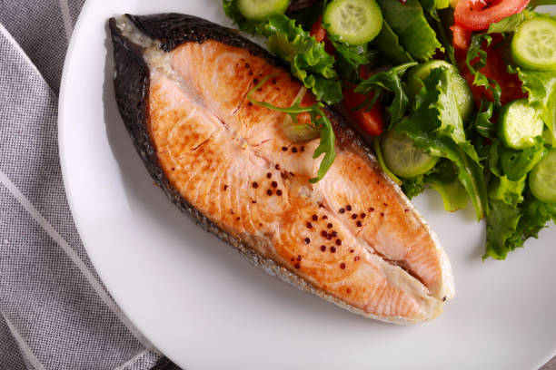 istock salmon steak with salad 1444771760