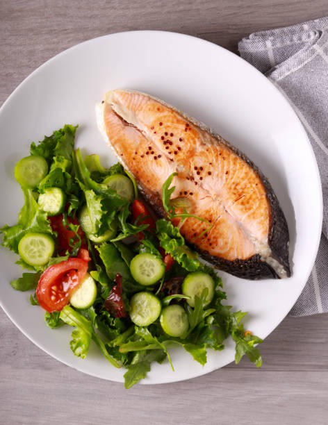 istock salmon steak with salad 1444772055