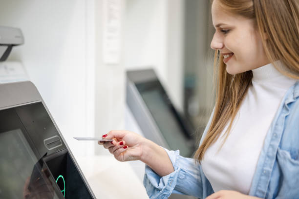 istock Woman withdrawing money at the ATM 1444772471