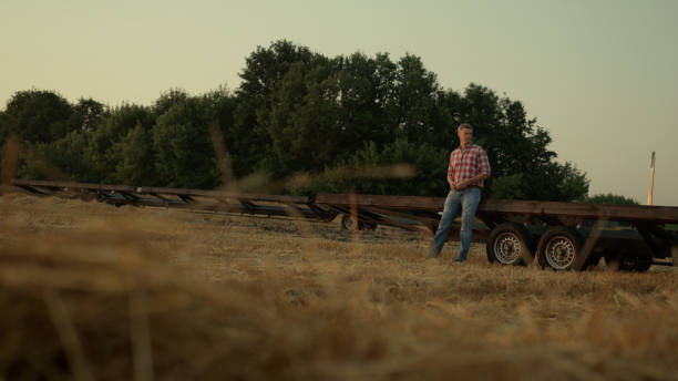 istock Farmer work wheat field at machine rural area view. Agribusiness concept. 1444774170