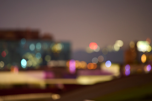 Night bokeh light, blur background of cityscape, blue color toned, abstract.