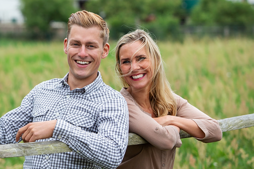 portrait of young happy laughing couple outside in nature